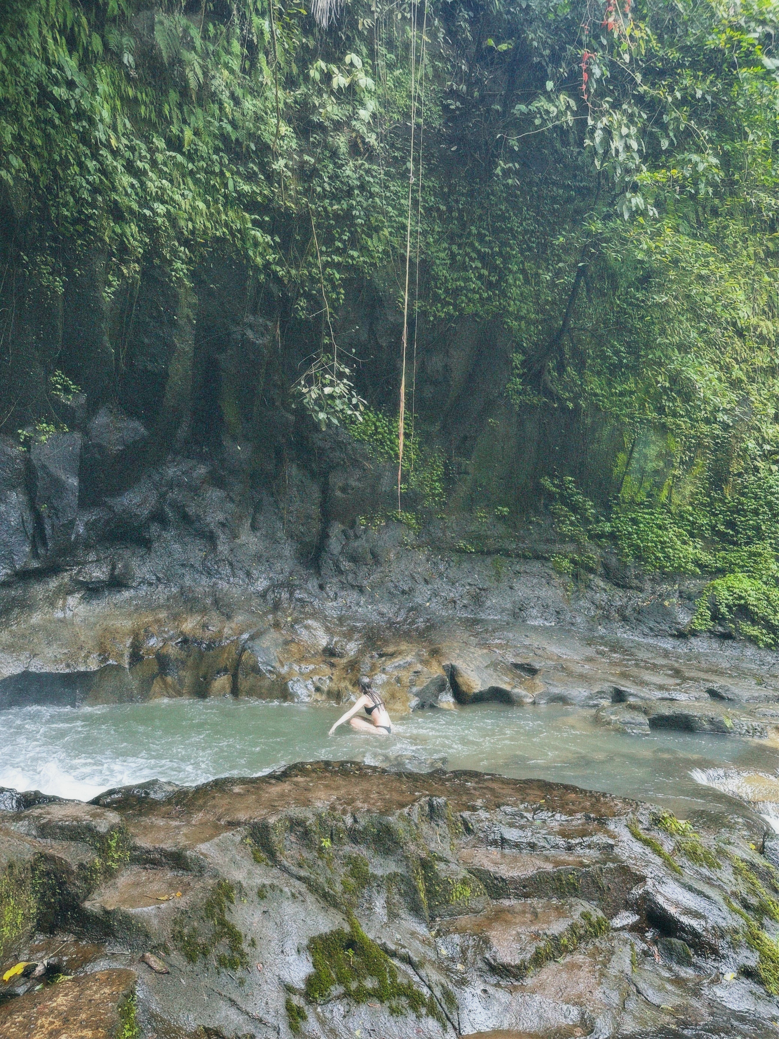 Honey House founder in Bali – waterfall moment capturing the story behind real relief and slow care.
